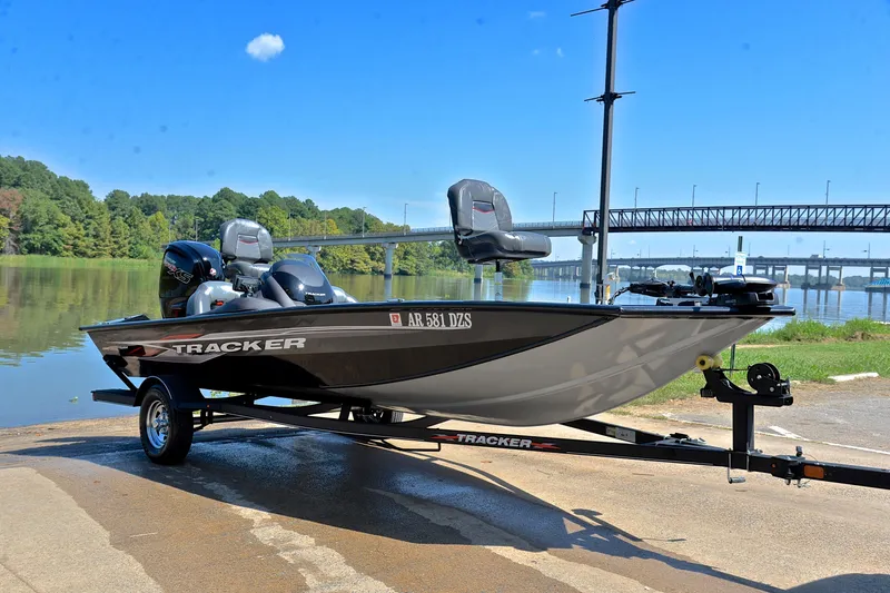 Slide: The Image of 2023 Bass Tracker PRO TEAM 190 boat on trailer by a scenic river. - 16