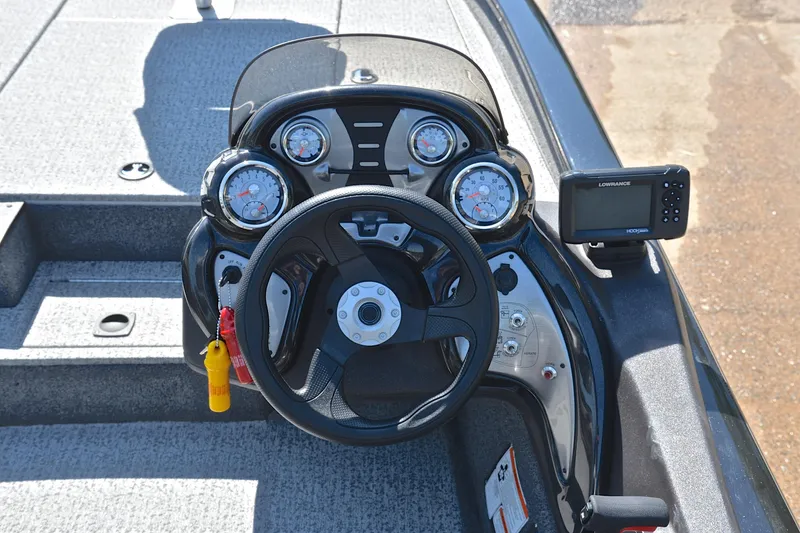 Slide: The Image of 2023 Bass Tracker PRO TEAM 190 dashboard with steering wheel and navigation system. - 26