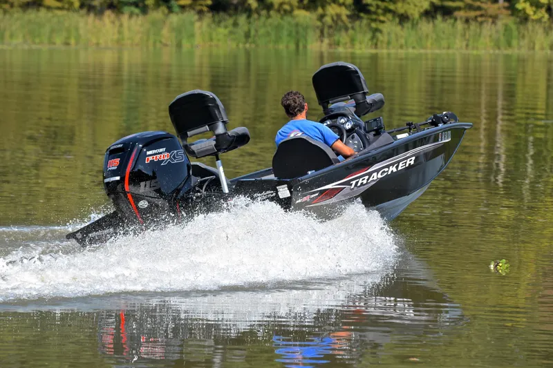 Slide: The Image of 2023 Bass Tracker PRO TEAM 190 boat speeding on a calm lake. - 5