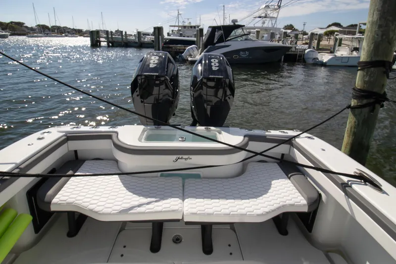 Slide: The Image of 2025 Yellowfin 32 Offshore boat with twin outboard engines docked at marina. - 10