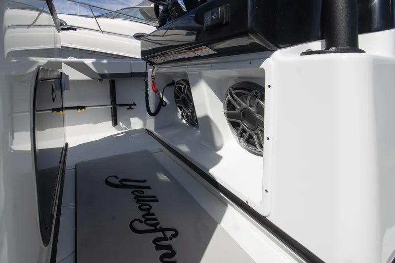 Slide: The Image of 2025 Yellowfin 32 Offshore boat interior with speakers and branded mat. - 12
