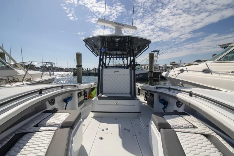Slide: The Image of 2025 Yellowfin 32 Offshore boat interior at marina, featuring sleek seating and modern design. - 3