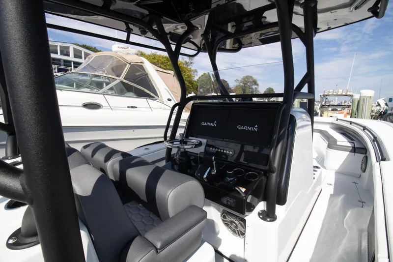 Slide: The Image of 2025 Yellowfin 32 Offshore boat interior with Garmin navigation system and seating. - 6