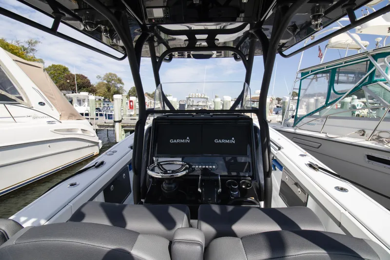 Slide: The Image of 2025 Yellowfin 32 Offshore boat interior with Garmin navigation system at marina. - 7