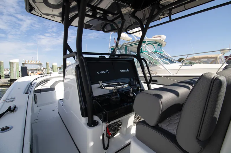 Slide: The Image of 2025 Yellowfin 32 Offshore boat interior with Garmin navigation system at marina. - 8