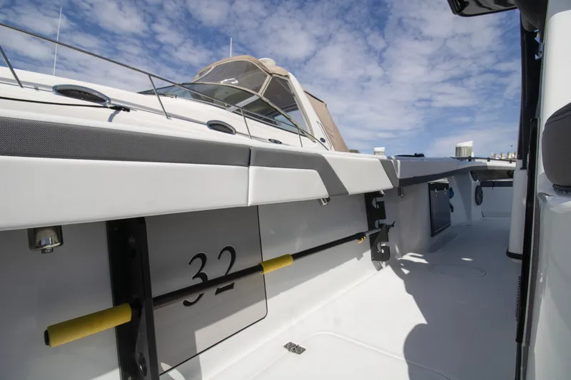 Slide: The Image of 2025 Yellowfin 32 Offshore boat deck under a clear blue sky. - 9