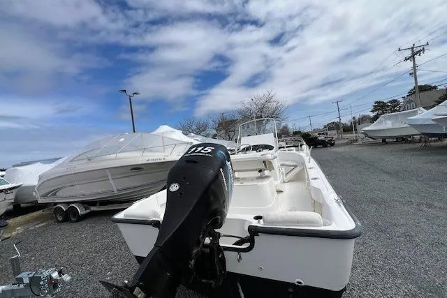 Slide: The Image of 2005 Boston Whaler 190 Nantucket boat with outboard motor, parked on gravel lot. - 12