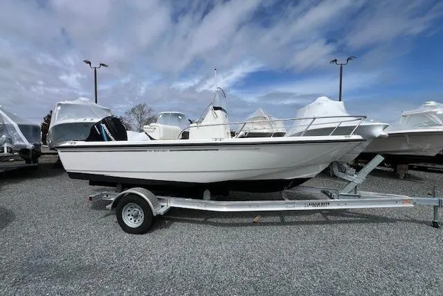 Slide: The Image of 2005 Boston Whaler 190 Nantucket boat on trailer under cloudy sky. - 14
