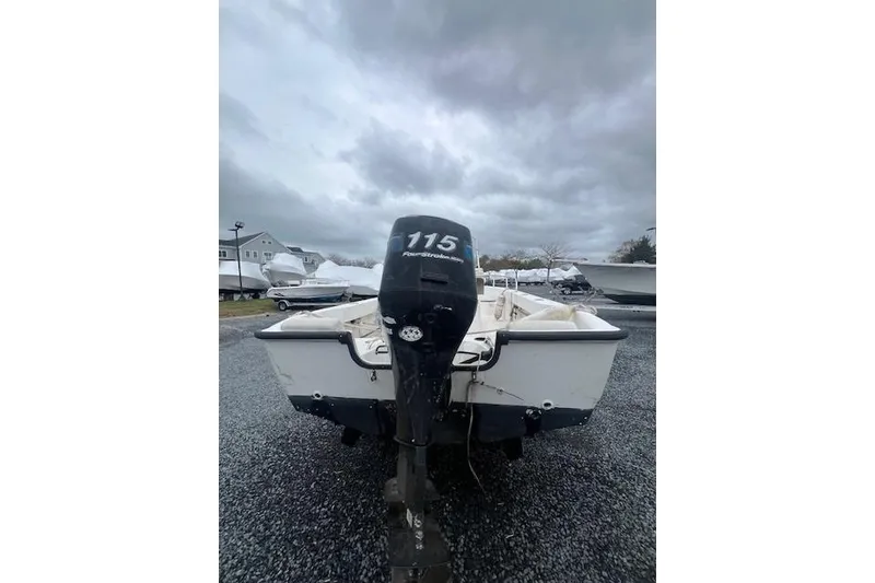 Slide: The Image of 2005 Boston Whaler 190 Nantucket boat with 115 FourStroke engine, parked outdoors. - 15