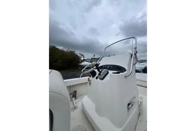 Slide: The Image of 2005 Boston Whaler 190 Nantucket boat console under cloudy sky. - 23