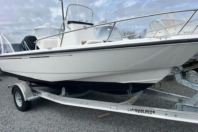 Slide: The Image of 2005 Boston Whaler 190 Nantucket boat on Load Rite trailer, parked on gravel. - 5
