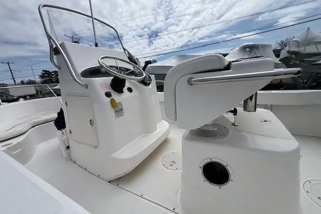 Slide: The Image of 2005 Boston Whaler 190 Nantucket boat interior with steering console and seating. - 7