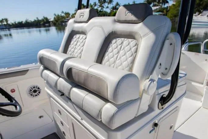 Slide: The Image of 2026 World Cat 325 CC boat interior with storage drawers and seating. - 12