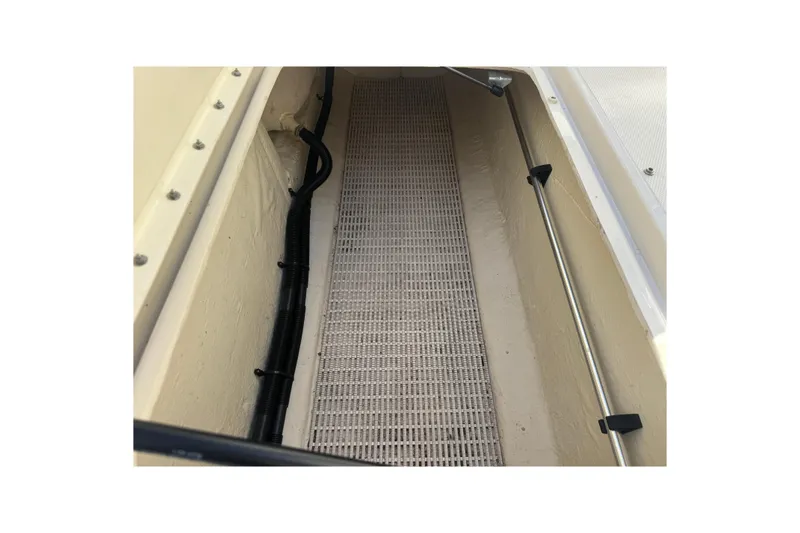 Slide: The Image of Storage compartment of a 2005 Sea Ray 240 Sundeck boat, featuring a lined interior. - 15