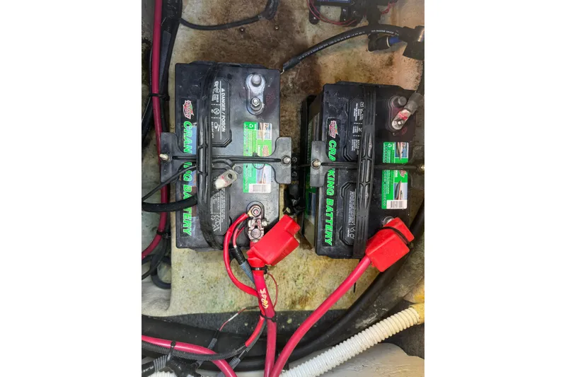 Slide: The Image of Batteries in a 2005 Sea Ray 240 Sundeck boat, connected with red and black cables. - 16