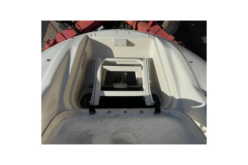 Slide: The Image of 2005 Sea Ray 240 Sundeck boat interior with storage compartment and ladder. - 20