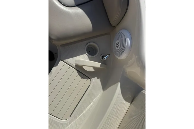 Slide: The Image of 2005 Sea Ray 240 Sundeck interior with speaker and cup holder detail. - 21