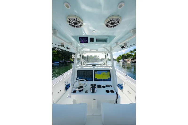 Slide: The Image of 2021 Yellowfin 39 Offshore boat cockpit with navigation screens and steering wheel. - 13