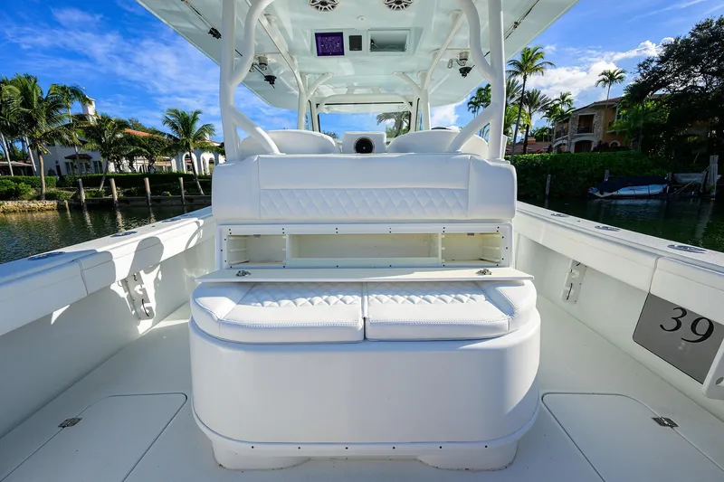 Slide: The Image of 2021 Yellowfin 39 Offshore boat interior with white seating and open storage. - 17