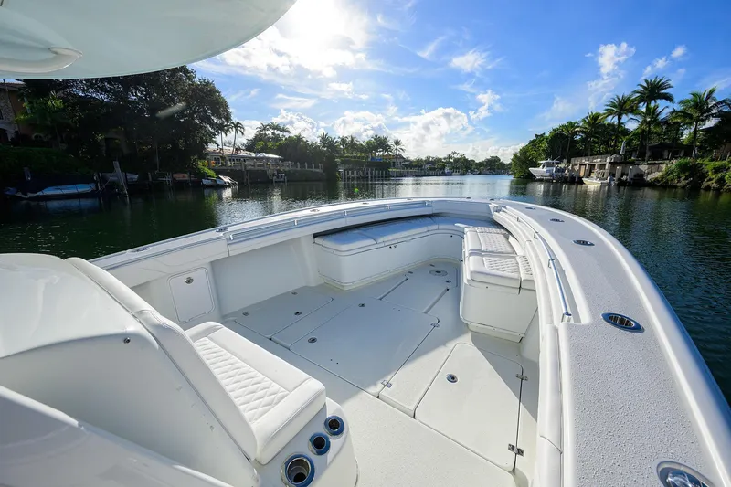 Slide: The Image of 2021 Yellowfin 39 Offshore boat on a serene waterway under a clear blue sky. - 28