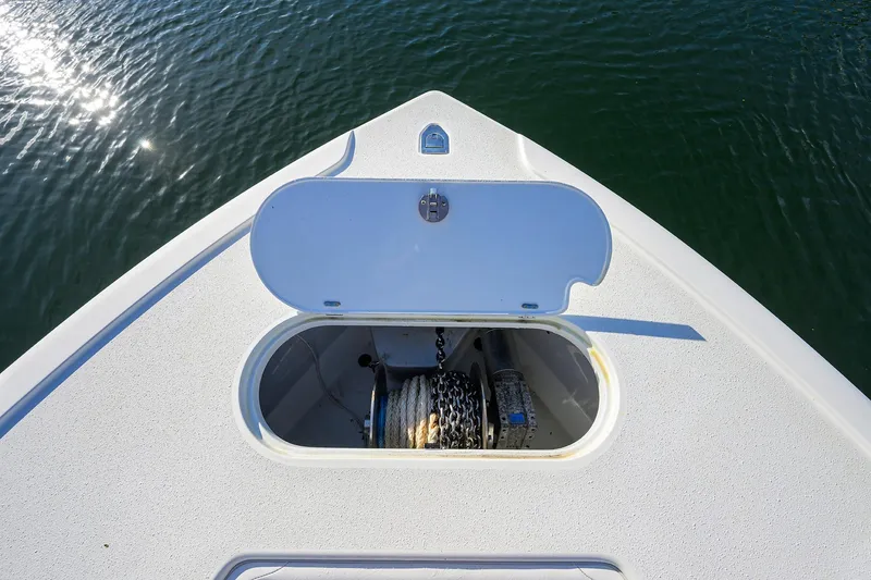 Slide: The Image of 2021 Yellowfin 39 Offshore boat anchor compartment on calm water. - 29