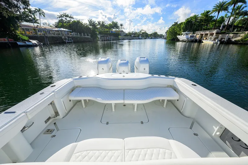 Slide: The Image of 2021 Yellowfin 39 Offshore boat on a serene waterway with lush greenery. - 31