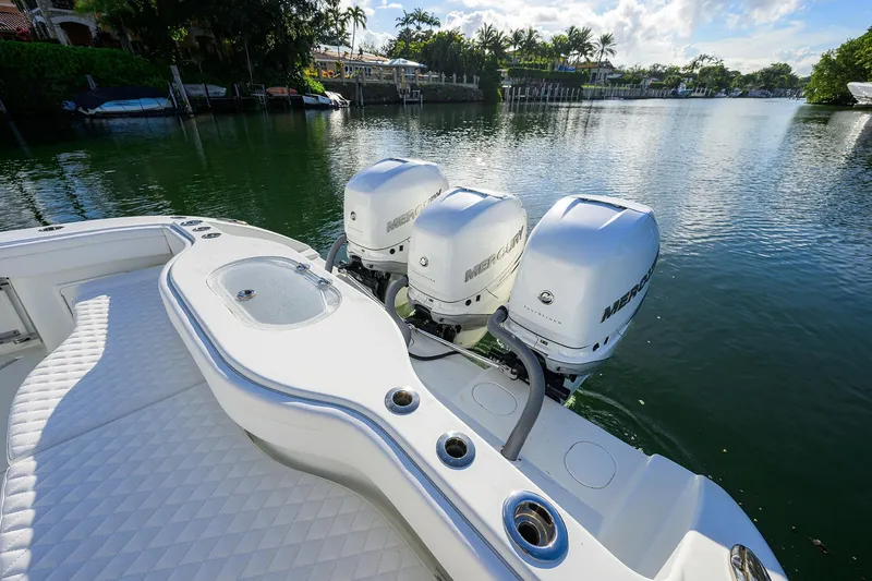 Slide: The Image of 2021 Yellowfin 39 Offshore boat with triple Mercury engines on a serene waterway. - 35