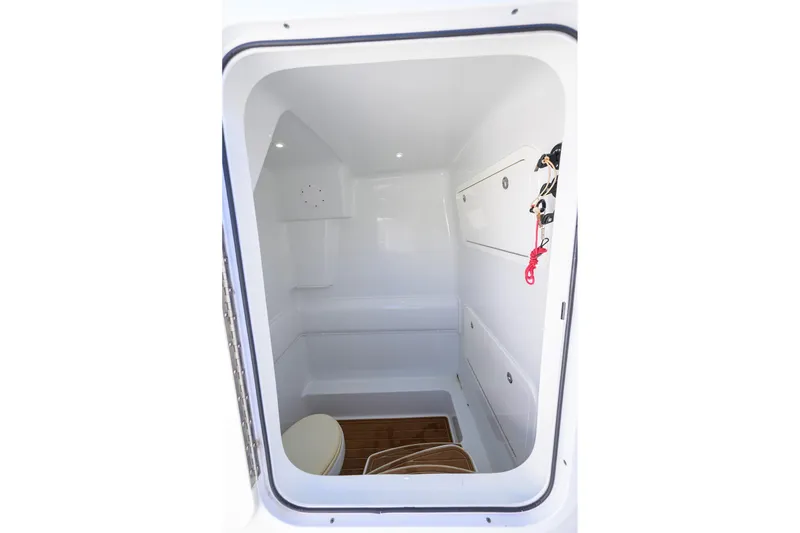 Slide: The Image of 2021 Yellowfin 39 Offshore boat interior with white cabin and wooden flooring. - 38