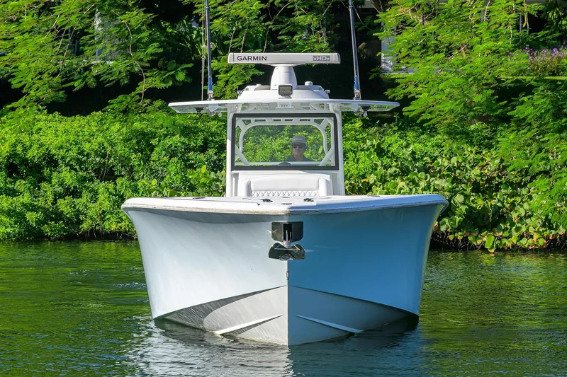 Slide: The Image of 2021 Yellowfin 39 Offshore boat cruising on a lush, green waterway. - 4