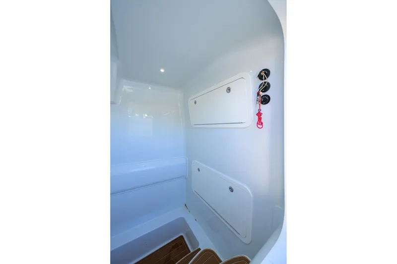 Slide: The Image of 2021 Yellowfin 39 Offshore interior storage compartments with sleek white finish. - 41