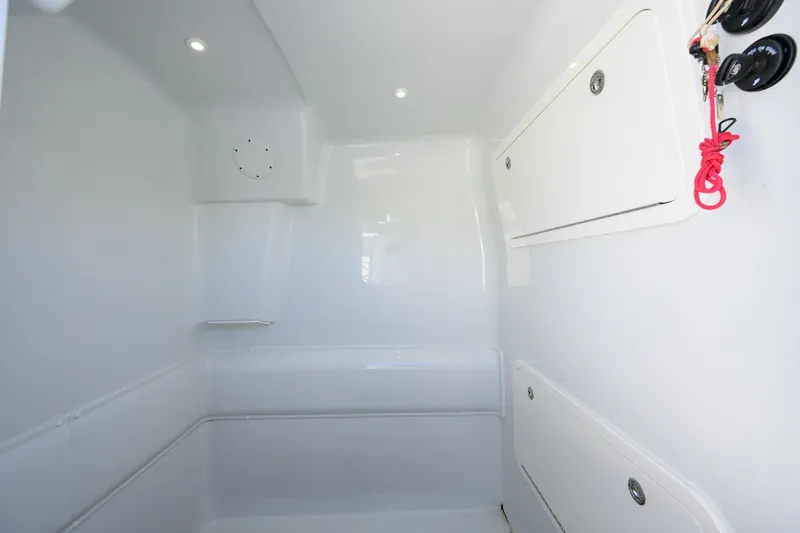 Slide: The Image of 2021 Yellowfin 39 Offshore interior cabin with white storage compartments. - 42