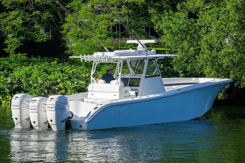 Slide: The Image of 2021 Yellowfin 39 Offshore boat with triple outboard engines on a serene waterway. - 6