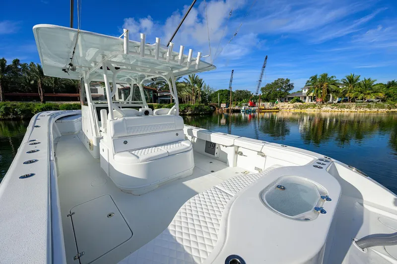 Slide: The Image of 2021 Yellowfin 39 Offshore boat with spacious deck, docked by a scenic waterfront. - 9