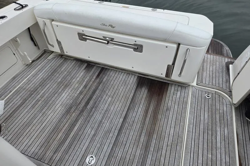 Slide: The Image of 2008 Sea Ray 290 Amberjack boat deck with wood finish and white seating. - 11