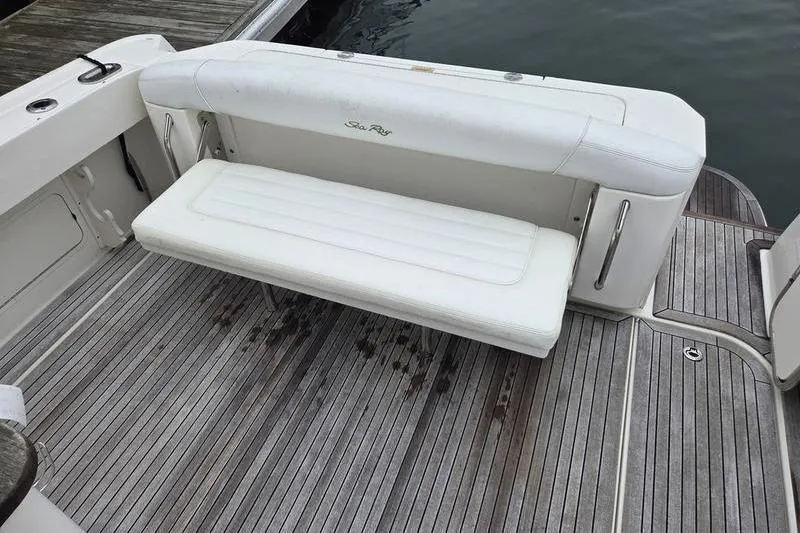 Slide: The Image of 2008 Sea Ray 290 Amberjack boat with white cushioned seating on teak deck. - 12