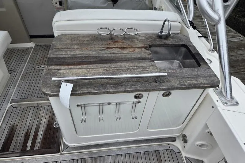 Slide: The Image of 2008 Sea Ray 290 Amberjack boat kitchenette with sink and storage. - 13