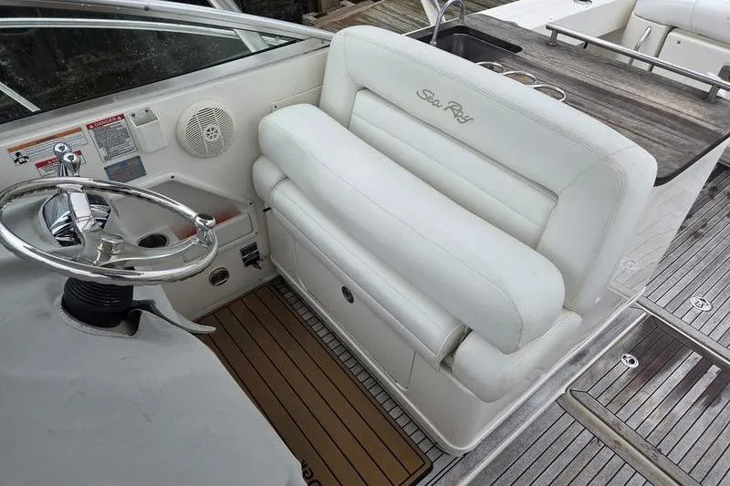 Slide: The Image of 2008 Sea Ray 290 Amberjack helm with white seating and steering wheel. - 14