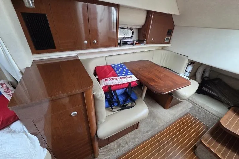 Slide: The Image of Interior of 2008 Sea Ray 290 Amberjack with wooden cabinetry and seating area. - 20