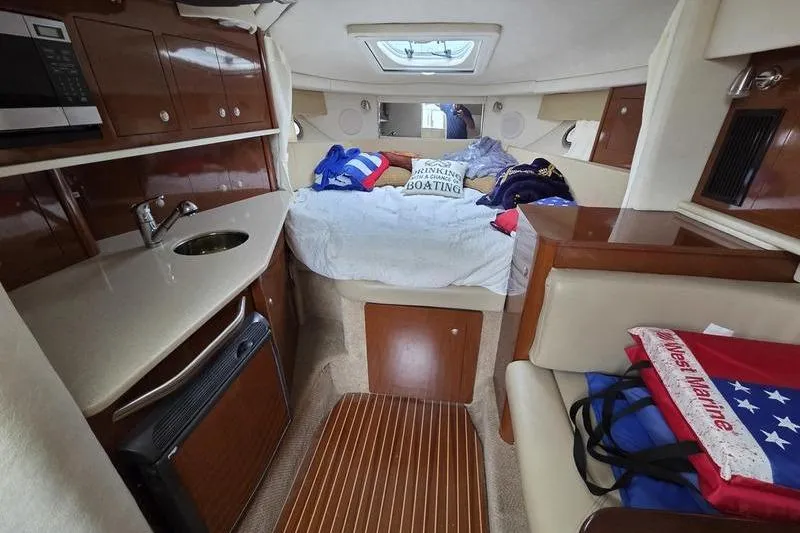 Slide: The Image of Interior of 2008 Sea Ray 290 Amberjack boat with cozy cabin and kitchenette. - 21