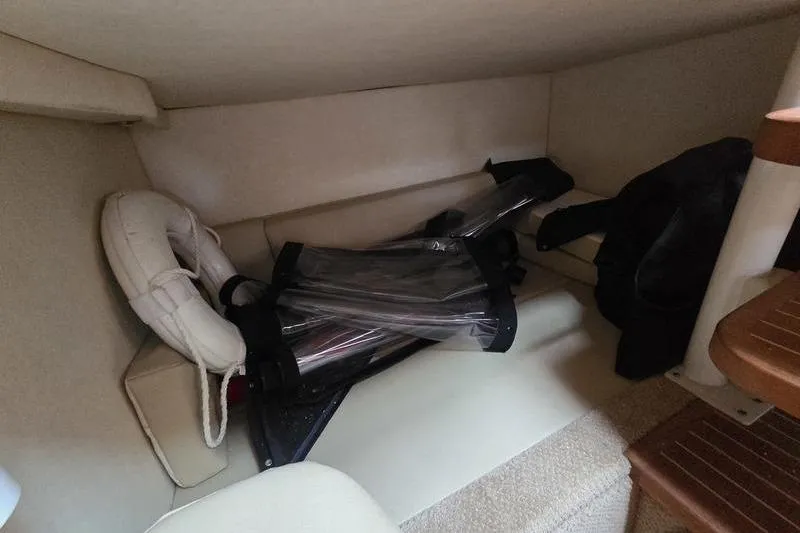 Slide: The Image of Interior cabin of 2008 Sea Ray 290 Amberjack with life preserver and folded equipment. - 24