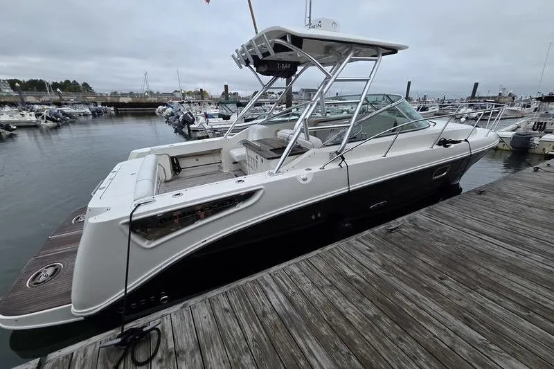 Slide: The Image of 2008 Sea Ray 290 Amberjack boat docked at a marina on a cloudy day. - 4