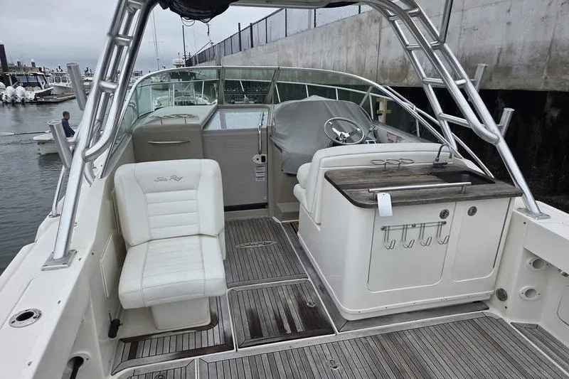 Slide: The Image of 2008 Sea Ray 290 Amberjack boat interior with seating and helm, docked at marina. - 5