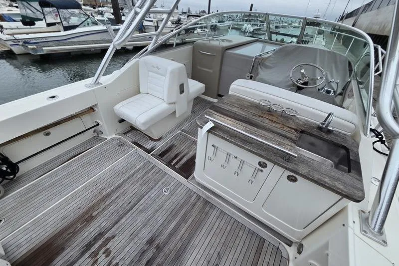 Slide: The Image of 2008 Sea Ray 290 Amberjack boat interior with seating and kitchenette. - 8