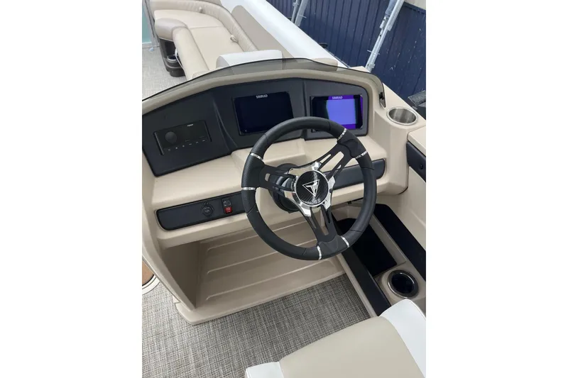 Slide: The Image of 2026 Tahoe 25 LTZ Entertainer boat dashboard with steering wheel and digital displays. - 7