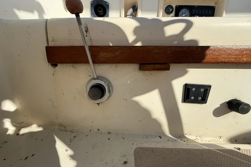 Slide: The Image of Cockpit controls of a 1988 Island Packet 27 sailboat, featuring throttle and instrument panel. - 13