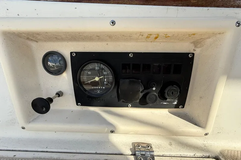 Slide: The Image of Control panel of a 1988 Island Packet 27 sailboat with fuel gauge and RPM meter. - 14