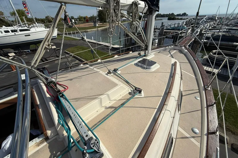 Slide: The Image of 1988 Island Packet 27 sailboat deck with rigging, docked at marina. - 19