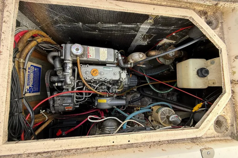 Slide: The Image of Engine compartment of a 1988 Island Packet 27 sailboat, showing detailed wiring and components. - 21