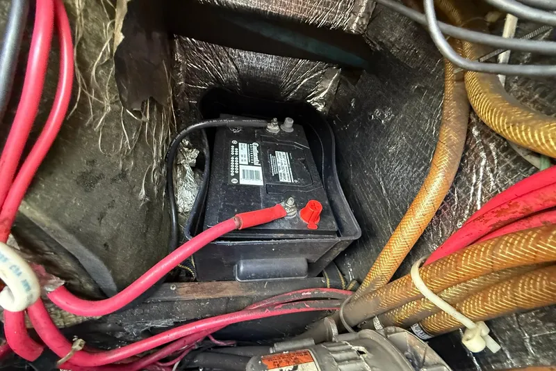Slide: The Image of Battery compartment of a 1988 Island Packet 27 sailboat with wiring and insulation. - 22