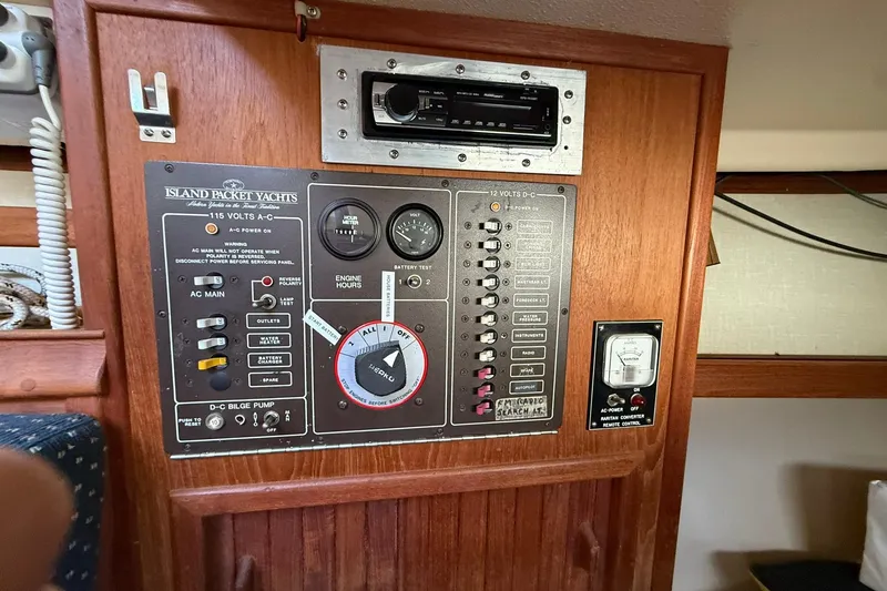 Slide: The Image of Control panel of a 1988 Island Packet 27 yacht, featuring various switches and gauges. - 25